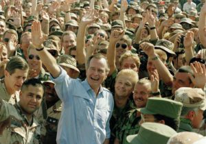 FILE -- In this Nov. 22, 1990 file photo, President George Bush poses with soldiers during a stop at an air base in Dhahran, Saudi Arabia. (ANSA/AP Photo/J. Scott Applewhite, File)