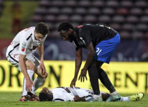 Dinamo Bucharest's Dorin Rotariu (L) and Victoria's Alexandru Buzbjuchi (R) give assistance to Dinamo's player  Patrick Claude Ekeng (down), who collapsed during the play-off soccer match Dinamo Bucharest vs Victoria, counting for the Romanian Premier Soccer League, on National Arena Stadium in Bucharest, Romania, 06 May 2016. EPA/-