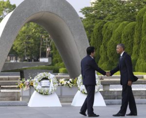 U.S. President Barack Obam, right, and Japanese Prime Minister Shinzo Abe shake hands after laying wreaths at Hiroshima Peace Memorial Park in Hiroshima, western, Japan, Friday, May 27, 2016. Obama on Friday became the first sitting U.S. president to visit the site of the world's first atomic bomb attack, bringing global attention both to survivors and to his unfulfilled vision of a world without nuclear weapons. Atomic Bomb Dome is seen in the background. (ANSA/AP Photo/Carolyn Kaster)
