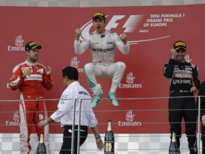 Mercedes driver Nico Rosberg of Germany, center, winner of the race, jumps in celebration on the podium, flanked by second place Ferrari driver Sebastian Vettel of Germany, left, and third place Force India driver Sergio Perez of Mexico, during the Formula One Grand Prix of Europe at the Baku circuit, in Baku, Azerbaijan, Sunday, June 19, 2016.  (ANSA/AP Photo/Luca Bruno)