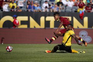 Venezuela's Josef Martinez , top,  takes a shot on goal under pressure from Jamaica's Wes Morgan during a Copa America Centenario Group C soccer match at Soldier Field in Chicago, Sunday, June 5, 2016. (ANSA/AP Photo/Charles Rex Arbogast)