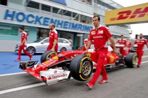 Technicians push the car of German Formula 1 race driver Sebastian Vettel of Scuderia Ferrari to the FIA inspection at Hockenheimring in Hockenheim, Germany, 28 July 2016. The Grand Prix of Germany starts on 31 July 2016.  EPA/JAN WOITAS