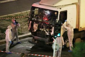 Authorities investigate a truck after it plowed through Bastille Day revelers in the French resort city of Nice, France, Thursday, July 14, 2016.  (Sasha Goldsmith via AP)