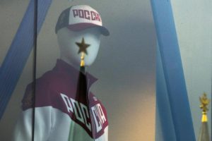 A mannequin dressed in a Russian Olympics National team uniform is on display in a shop window, with the Kremlin tower star reflected on a window glass, in Moscow, Russia, Tuesday, July 19, 2016. (ANSA/AP Photo/Pavel Golovkin)  