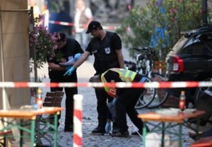 Police officers operate on a scene following an explosion in Ansbach, Germany, 25 July 2016. EPA/DANIEL KARMANN