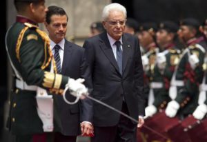 Mexican President Enrique Pena Nieto, center left, escorts Italian President Sergio Mattarella past an honor guard during an official welcoming ceremony at the National Palace in Mexico City, Monday, July 4, 2016. (ANSA/AP Photo/Rebecca Blackwell) 