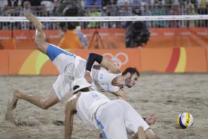 Italy's Paolo Nicolai, above, can't reach a ball as teammate Daniele Lupo looks on while playing against Brazil during the men's beach volleyball gold medal match at the 2016 Summer Olympics in Rio de Janeiro, Brazil, Friday, Aug. 19, 2016. (ANSA/AP Photo/Petr David Josek)
