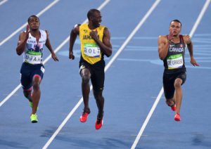 Jamaica's Usain Bolt, center, smiles as he looks at Canada's Andre De Grasse, right, during a semifinal in the men's 100 meters at the Olympic Summer Games in Rio de Janeiro, Brazil, on Sunday, Augl. 14, 2016. Britain's Chijindu Ujah is at left. (Sean Kilpatrick/The Canadian Press via AP)
