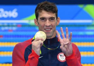 Michael Phelps of USA celebrates his fourth Rio 2016 gold medal during the medal ceremony for the men's 200m Individual Medley Final race of the Rio 2016 Olympic Games Swimming events at Olympic Aquatics Stadium at the Olympic Park in Rio de Janeiro, Brazil, 11 August 2016.  EPA/DEAN LEWIS