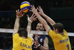Ivan Zaytsev of Italy (C) spikes the ball against Lucas Saatkam (L) and Bruno Mossa Rezende (R) of Brazil during the men's Volleyball gold medal match of the Rio 2016 Olympic Games at Maracanazinho indoor arena in Rio de Janeiro, Brazil, 21 August 2016.  EPA/JAVIER ETXEZARRETA