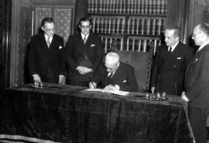 Il presidente della Repubblica Enrico De Nicola firma la costituzione italiana alla presenza di Alcide De Gasperi