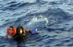 A videograb realesed by Italian Marina Militare shows scuba diver rescue of the shipwrecked by Italian marines in Sicily Canal, yesterday, 11 October 2013 were almost  50 people are dead.   ANSA/Marina Militare