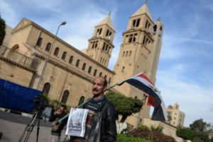 An Egyptian man holds a poster for Boutros Boutros-Ghali the former Secretary-General of the United Nations outside the Saints Peter and Paul Coptic Orthodox church in Abassya district, in Cairo, Egypt, 18 February 2016. EPA/MOHAMED HOSSAM
