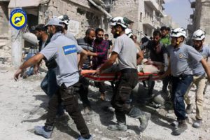 FILE - In this Wednesday, Sept. 21, 2016, file photo, provided by the Syrian Civil Defense White Helmets, rescue workers work the site of airstrikes in the al-Sakhour neighborhood of the rebel-held part of eastern Aleppo, Syria.  (Syrian Civil Defense White Helmets via AP, File)