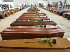 Coffin of victims are seen in an hangar of Lampedusa airport on October 5, 2013 after a boat with migrants sank killing more than hundred people. Italy mourned today the 300 African asylum-seekers feared dead in the worst ever Mediterranean refugee disaster, as the government appealed for Europe to stem the influx of migrants. Italian emergency services hoped to resume the search for bodies on October 5, 2013 despite rough seas after the accident, in which 111 African asylum-seekers are confirmed dead and around 200 more are still missing. AFP PHOTO / ALBERTO PIZZOLI
