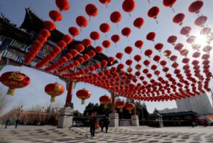 People walk past an entrance gate of Ditan Park decorated with red lanterns ahead of the Chinese Lunar New Year in Beijing, Tuesday, Feb. 2, 2016. Chinese will celebrate the Lunar New Year on Feb. 8 this year which marks the Year of Monkey on the Chinese zodiac. (ANSA/AP Photo/Andy Wong)