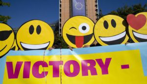 Members of a flashmob wear Emoji-masks as they demonstrate in front of EU headquarters in Brussels on Tuesday, Aug. 30, 2016. The flashmob gathered activists calling on EU regulators to keep the internet free and open. (ANSA/AP Photo/Virginia Mayo)  --------------------------------------------------------------------------------------------