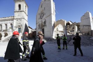 Monks walk in front of the Cathedral of St. Benedict in Norcia, central Italy, Italy, Monday, Oct. 31, 2016. The third powerful earthquake to hit Italy in two months spared human life Sunday but struck at the nation's identity, destroying a Benedictine cathedral, a medieval tower and other beloved landmarks that had survived the earlier jolts across a mountainous region of small historic towns. (ANSA/AP Photo/Gregorio Borgia) -------------------------------------------------------------------------------------------