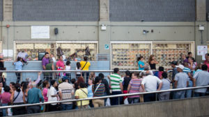 People queue up outside a supermarket in Caracas on January 13, 2015.  (Photo credit should read FEDERICO PARRA/AFP/Getty Images)