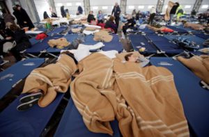 People take a rest after an earthquake in central Italy in a hangar used for recovery in Camerino, Italy October 27, 2016. REUTERS/Max Rossi