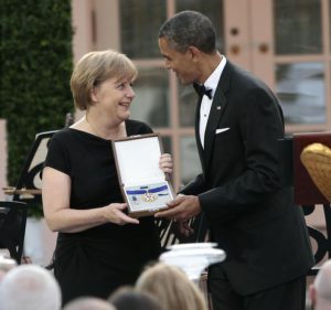 FILE - In this June 7, 2011 file photo. U.S. President Barack Obama, right, presents German Chancellor Angela Merkel with the Medal of Freedom  (ANSA/AP Photo/Pablo Martinez Monsivais, FILE)  --------------------------------------------------------------------------------------------