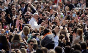 Pope Francis waves as he is driven through the crowd during his general audience, in St. Peter's Square, at the Vatican, Wednesday, March 27, 2013. (AP Photo/Andrew Medichini)