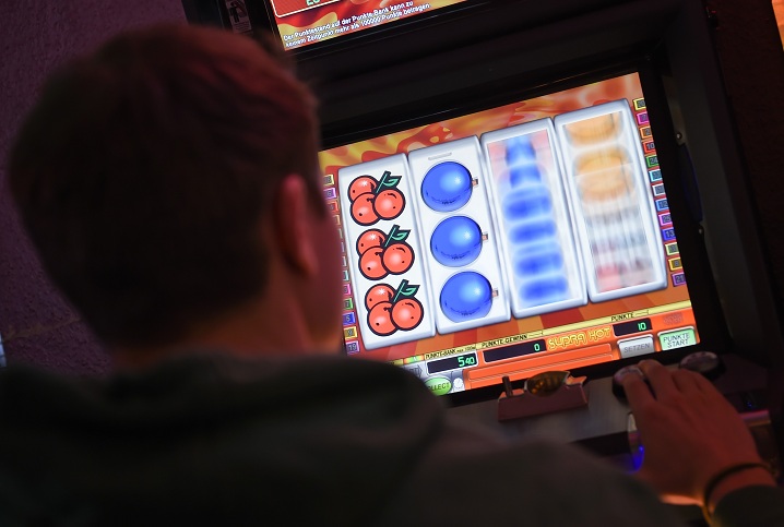 Una persona davanti ad una slot machine.