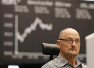A trader watches his screens when the curve of the German stock index DAX went up close to 10,000 points again at the stock market in Frankfurt, Germany, Tuesday, Aug. 25, 2015. (ANSA/AP Photo/Michael Probst)