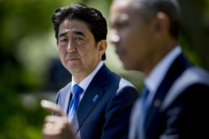 Shinzo Abe, Japan's prime minister, left, looks on as U.S. President Barack Obama speaks during a joint news conference in the Rose Garden of the White House in Washington, D.C., U.S., on Tuesday, April 28, 2015.  Photographer: Andrew Harrer/Bloomberg 