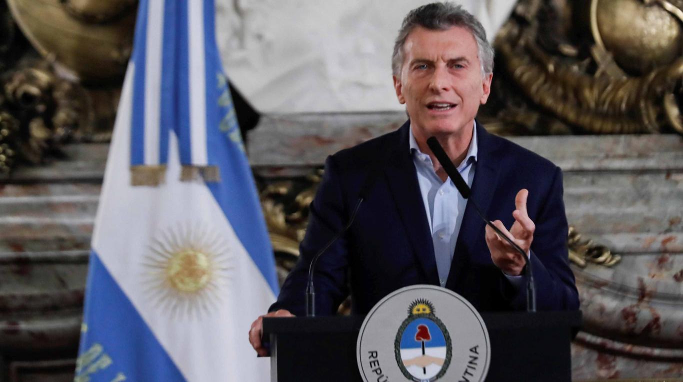 Mauricio Macri rilasciando dichiarazioni dalla Casa Rosada. Alle sue spalle la bandiera argentina