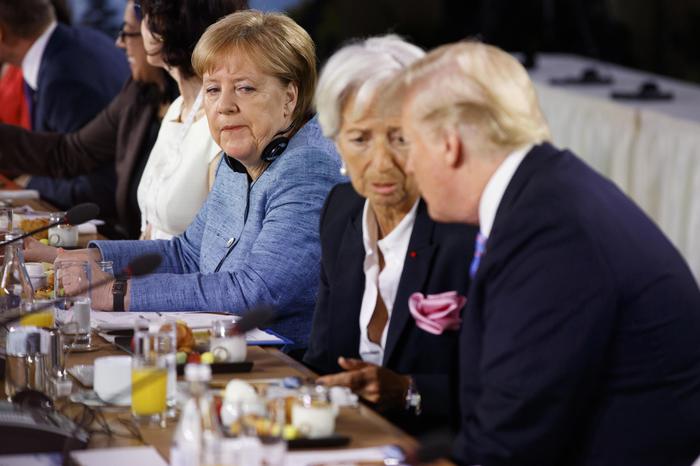 Angela Merkel guarda di sottecchi Donald Trump che parla con Christine Lagarde