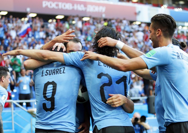 Gli uruguaiani abbracciano Suarez dopo il gol della vittoria.