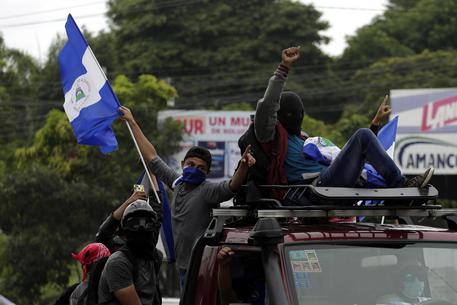 Cittadini protestano a bordo di motociclette e camion per le strade di Masaya (Nicaragua).