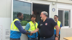 Il presidente della Regione Puglia, Michele Emiliano, in visita il villaggio stringe la mano ad un migrante