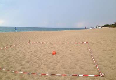 Tratto di spiaggia recintato da una cinta di polizia
