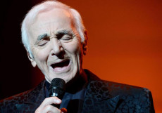 Un primo piano di Charles Aznavour mentre canta una delle sue canzoni