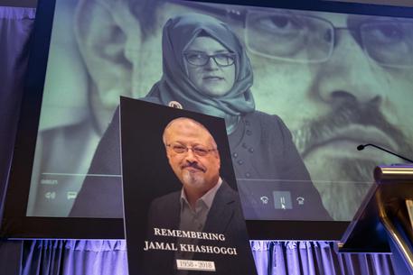 Una donna mostra la foto di Jamal Khashoggi.