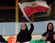 Tifose iraniane sugli spalti dello stadio sventolano la bandiera iraniana durante una partita della nazionale.