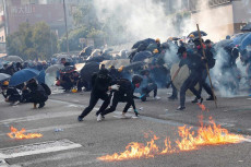 Studenti indietreggiano durante gli scontri con la polizia di Hong Kong, armati di bastoni di bambu di ferro, ombrelli e molotov. Immagine d´archivio.