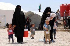 Donne con bambini in fuga dai campi dei rifugiati dopo l'assalto delle truppe turche