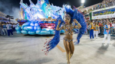 Una "garota" brasiliana marcia davanti una carrozza durante una sfilata al Carnevale di Rio de Janeiro. Foto d'archivio