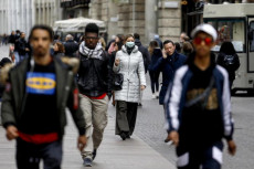Coronavirus, persone con la mascherina in una strada di Milano..