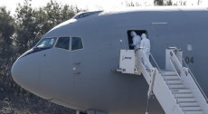 Personale sanitario entra al Boeing KC-767A dell'aviazione militare italiana con a bordo 57 passegeri Italiani arrivati da Wuhan alla base militare di Pratica di Mare, Roma.