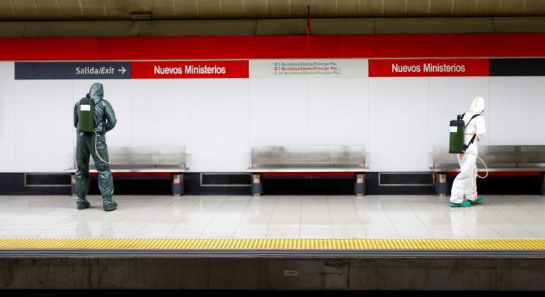 Coronavirus, addetti della sanità spagnola bonificano una stazione del metro di Madrid.