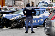 Agenti di polizia sul luogo dell'incidente tra un'auto della polizia e l'auto dei rapinatori che gli agenti hanno tentato di bloccare a Napoli,