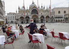 Il direttore del Caffè Quadri, Roberto Pepe, misura la distanza di sicurezza tra i tavoli a Piazza San Marco.