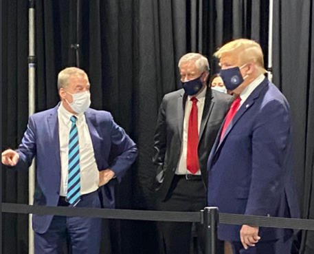 Il presidente americano Donald Trump (D )indossa una mascherina colore blue navy durante la sua visita ieri in una fabbrica della Ford in Michigan, in una immagine tratta dal profilo twitter di Jackie Speier.