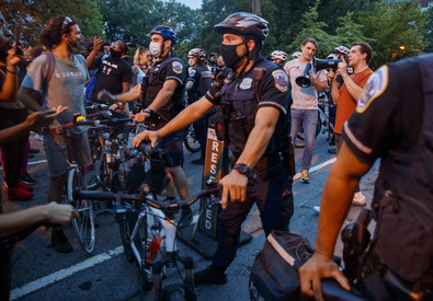 Agenti della polizia sbarrano la strada a manifestanti