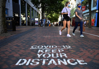 Una strada di Londra con la scritta "Covid 19. Mantieni la distanza"