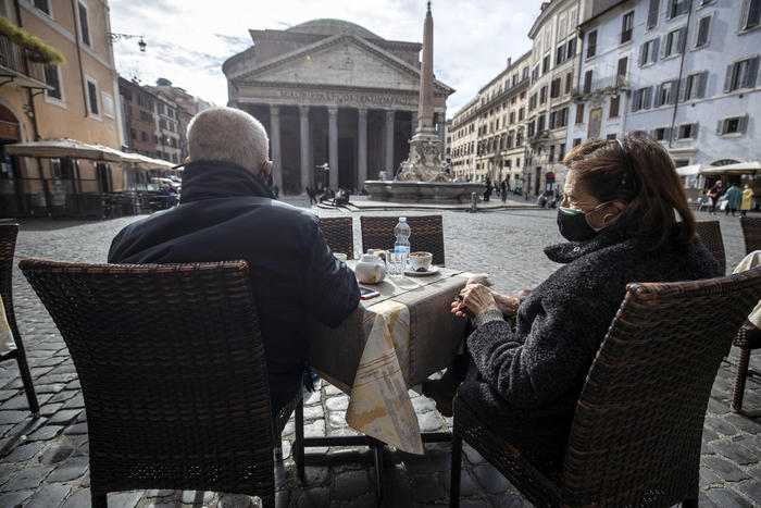 Due persone sedute al bar nella piazzetta del Pantheon a Roma.